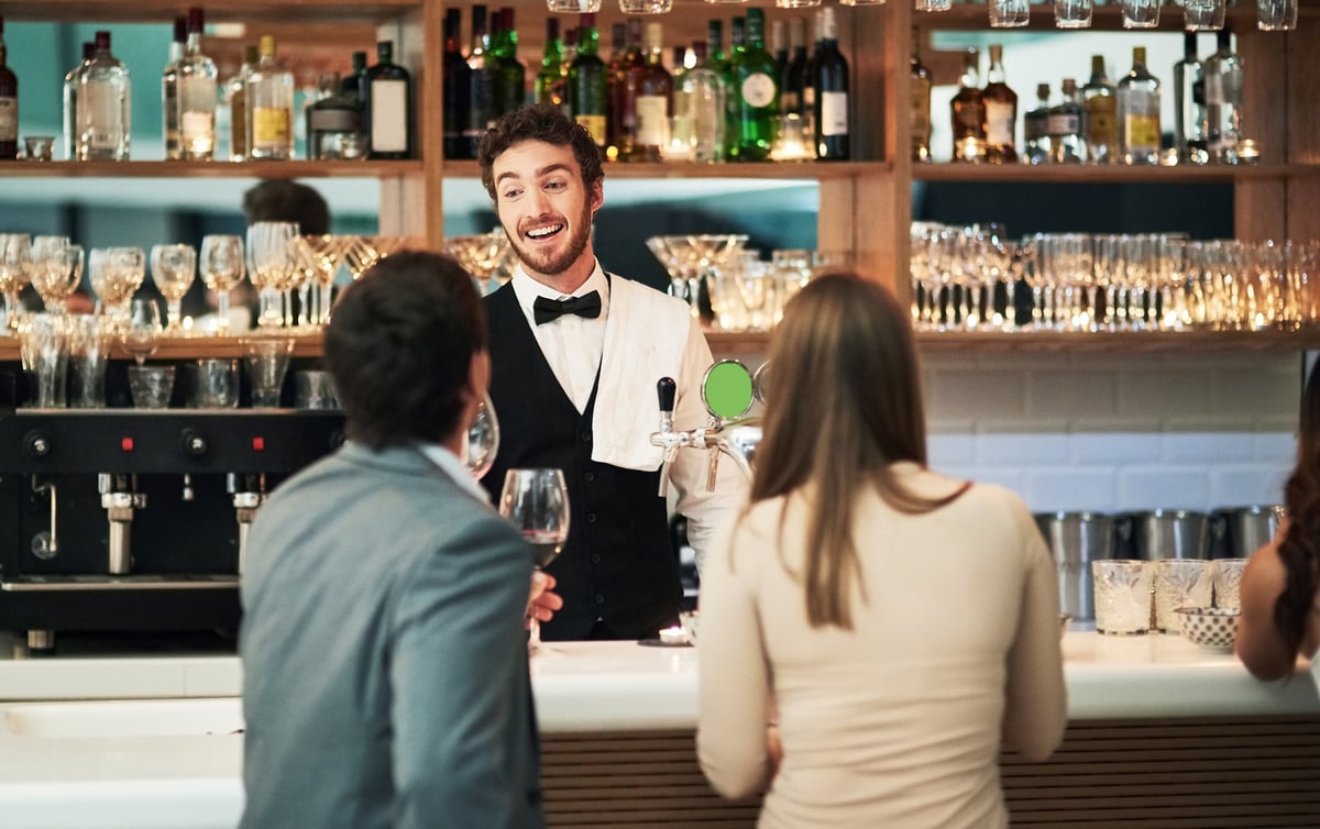Hospitality team member serving guests at an Everest Group venue
