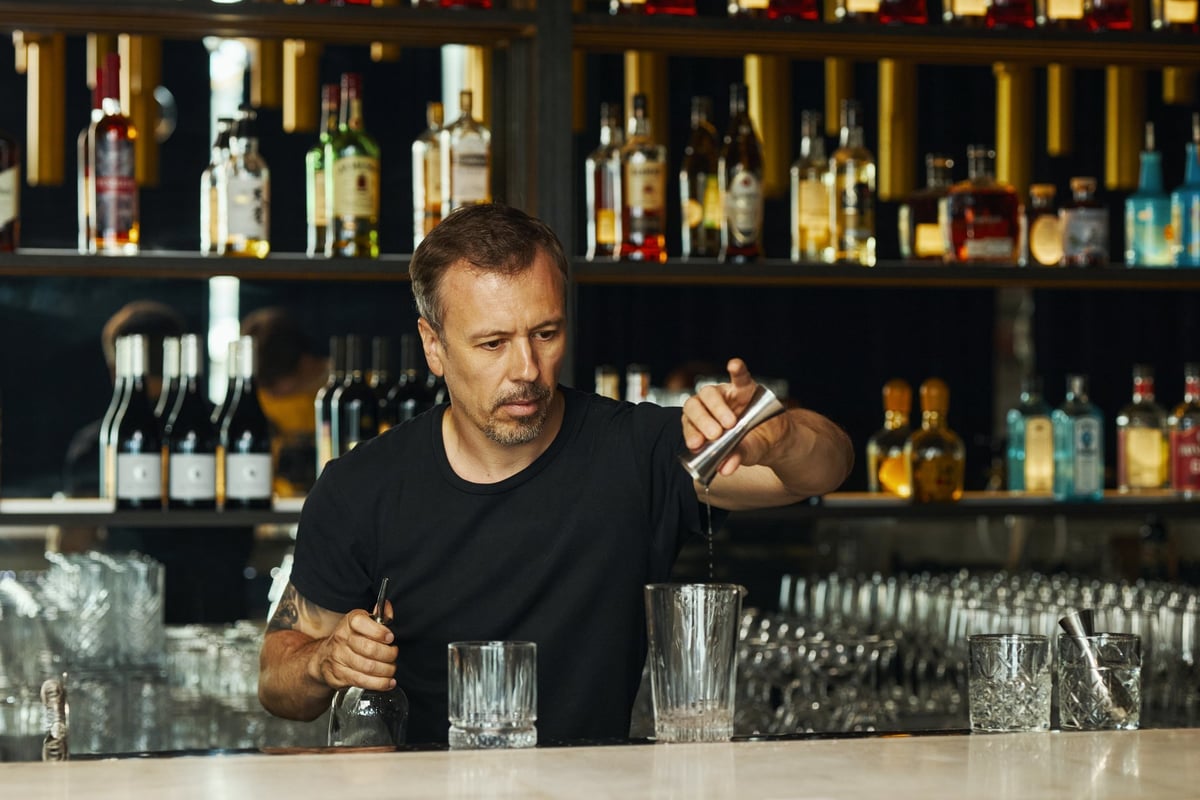 Bartender preparing a cocktail behind the bar counter